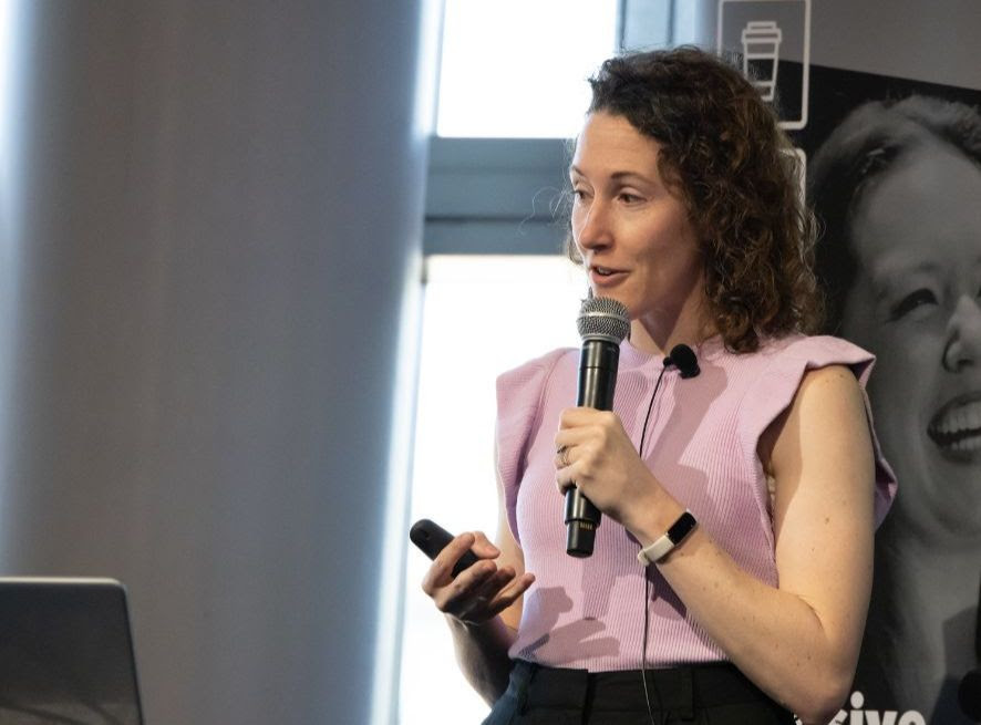 Samantha Di Lena delivering a keynote with a microphone in Perth